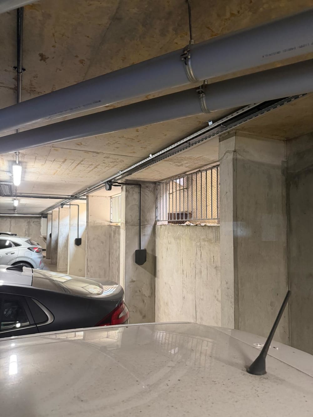 Easee EV chargers mounted on concrete pillars with overhead Wieland busbar at Portland Court underground car park in Hendon, London.