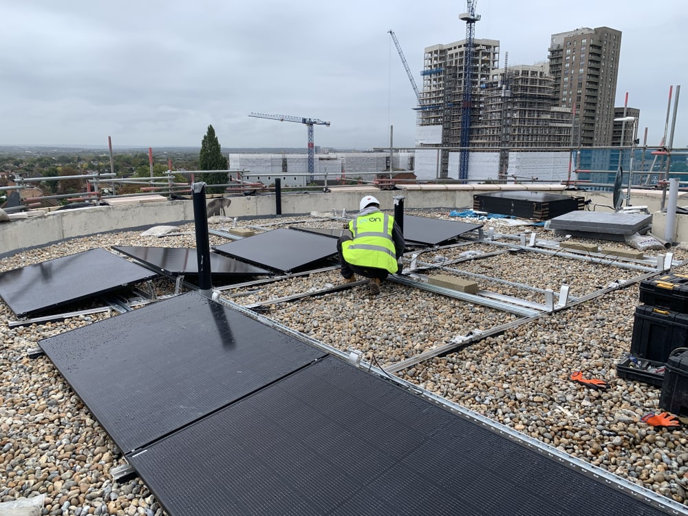 EV-ON engineer placing the first Jinko Tiger Neo 435W solar panels onto the K2 frame at The Mirador, Acton.