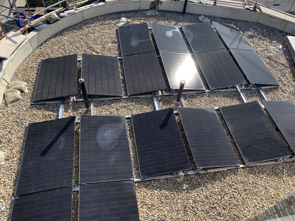 Completed 18 panel East/West solar array on the Level 6 curved flat roof at The Mirador, Acton, London.
