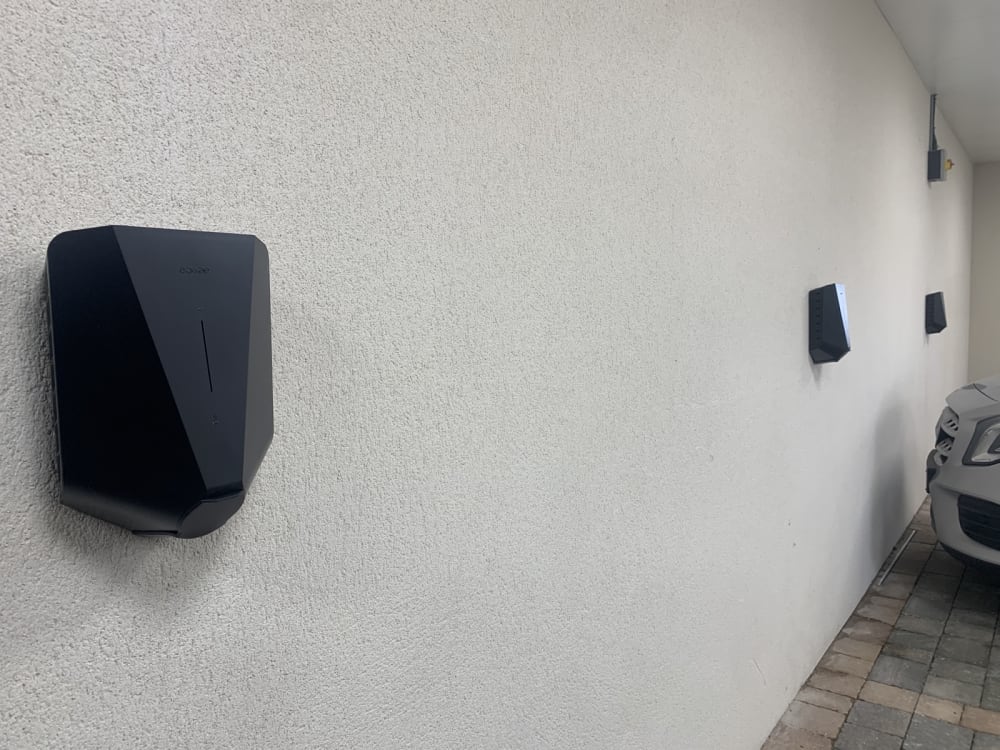 Two Easee One EV chargers installed on a wall in the car park at Wickliffe Court residential development, Hendon.