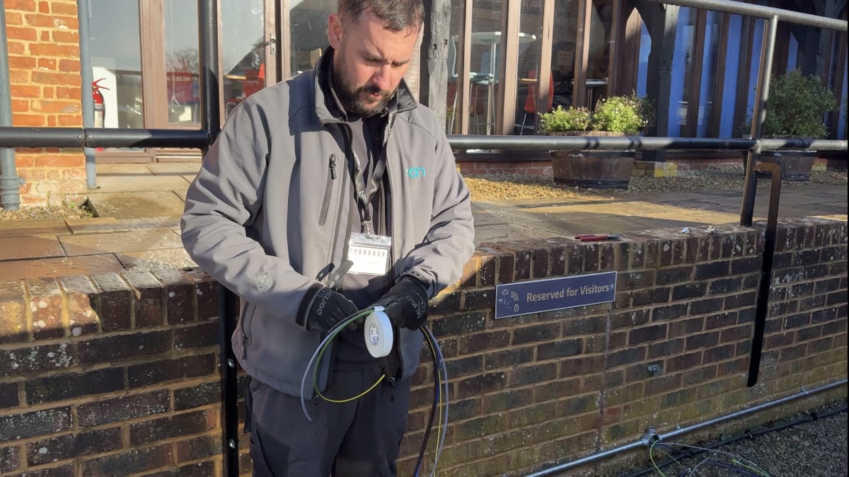 EV-ON engineer preparing cables during Easee charger installation at Purdicom workplace car park in Wantage.