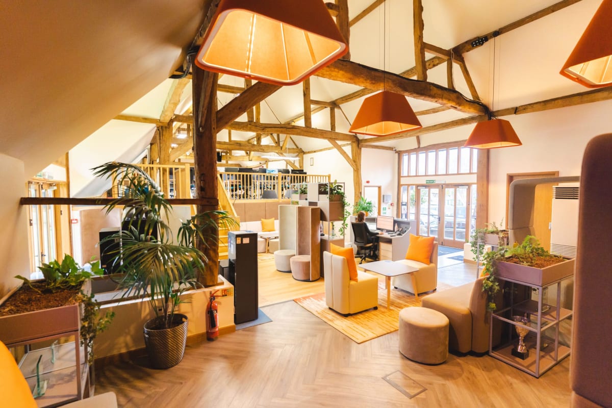 The converted barn interior at Purdicom headquarters in Wantage showing exposed timber beams and modern office space.