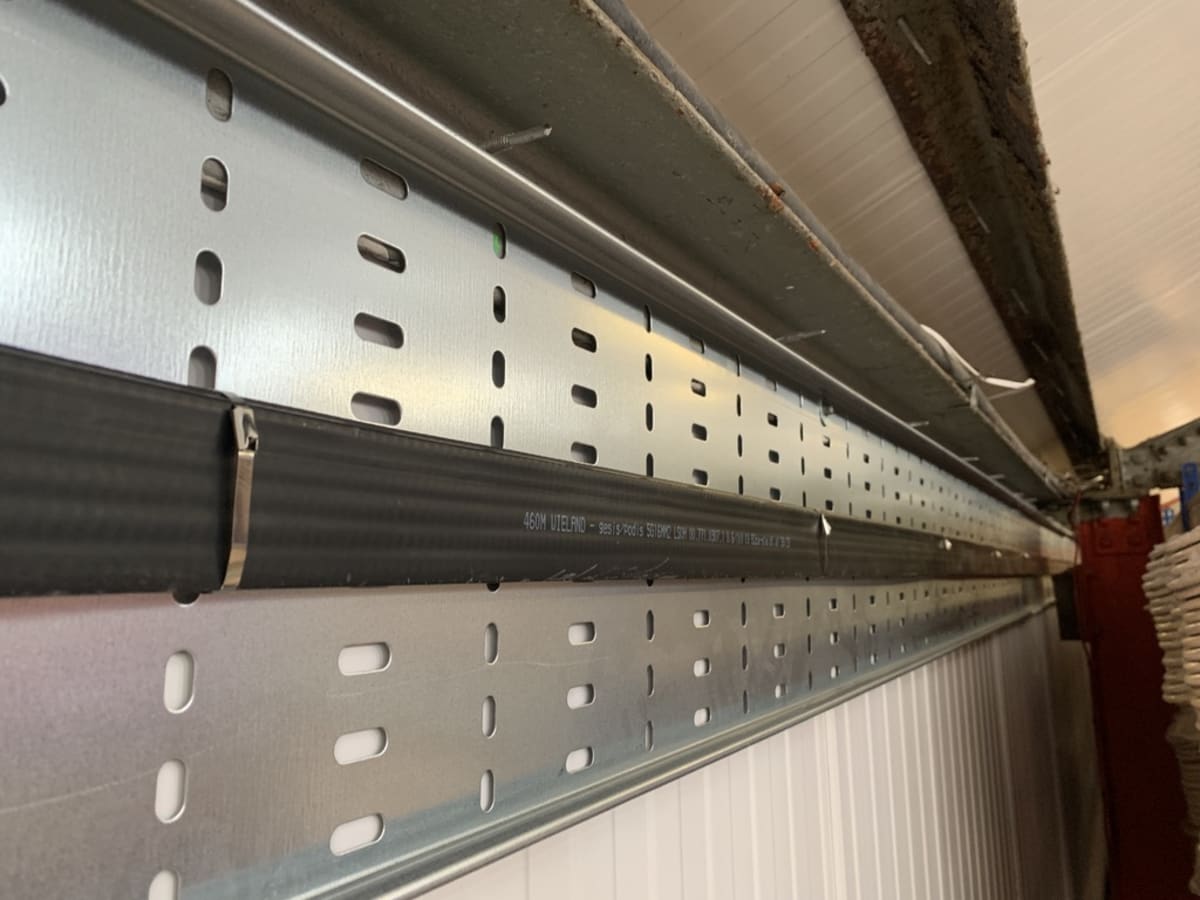 Wieland Podis flat cable on perforated cable tray installed at high level inside the Route One warehouse, Acton Turville
