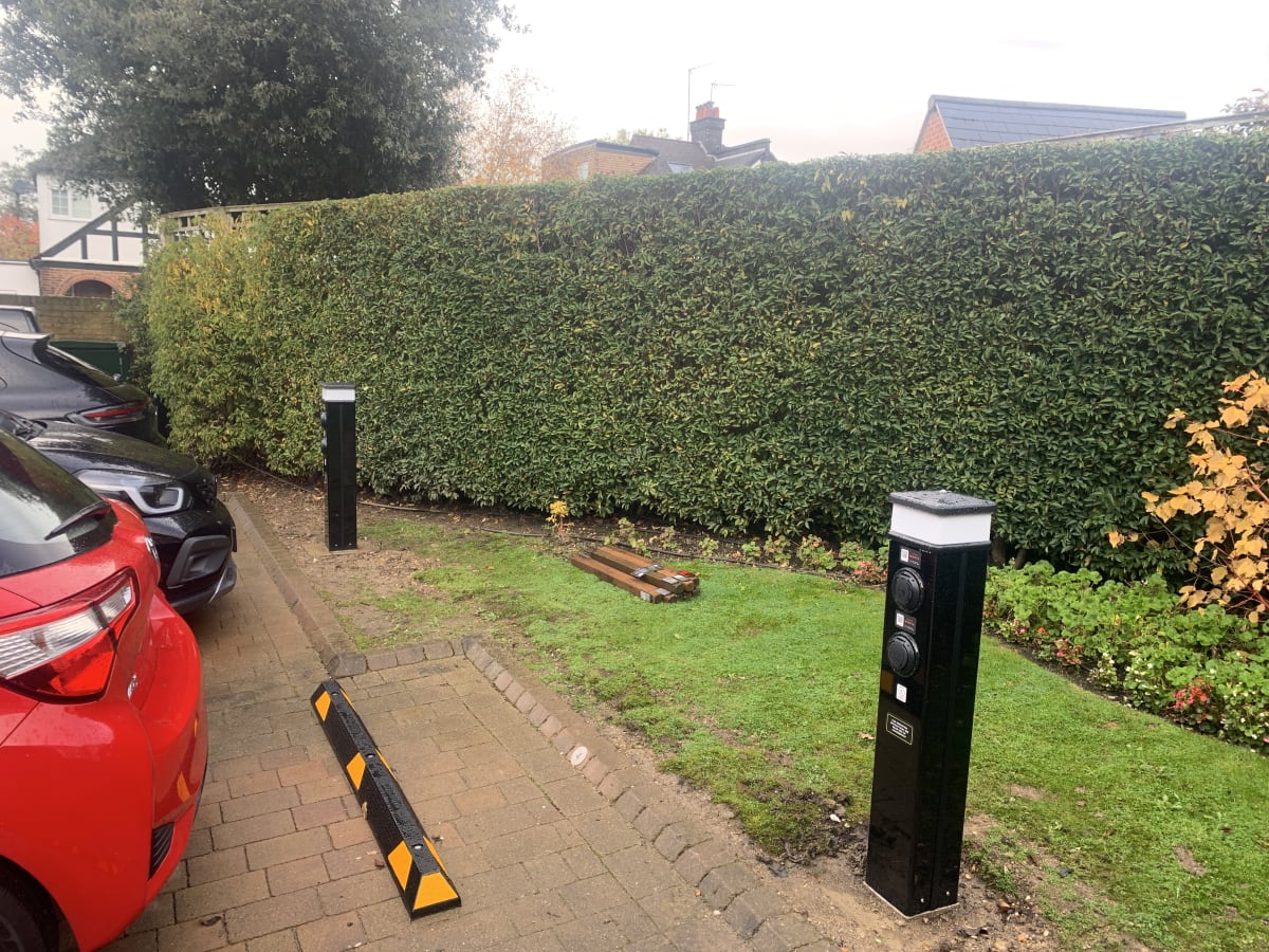 Two Rolec dual bollard EV chargers installed beside landscaped hedging at Ashby Lodge, Hendon
