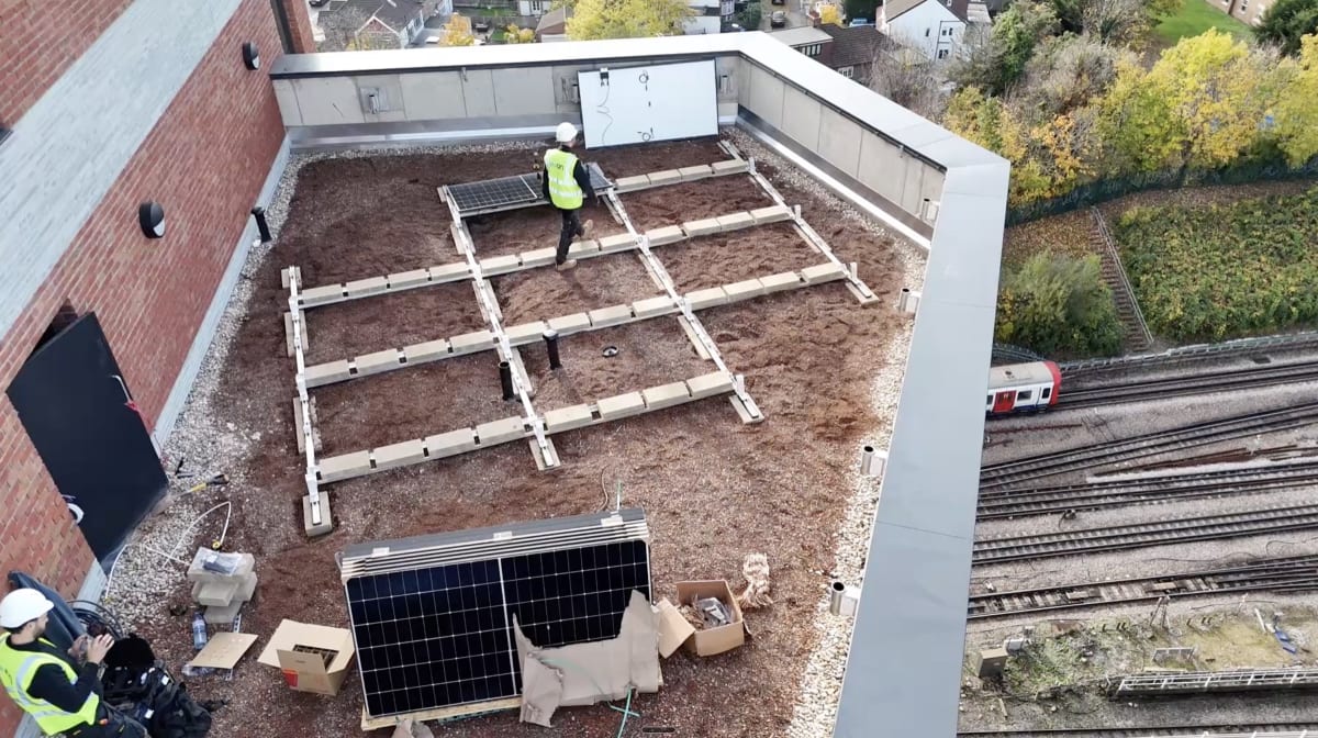 Drone view of K2 S-Dome mounting fully laid out on Brooke House 13th floor roof with first Longi panels ready, Gunnersbury Lane, Acton, London.