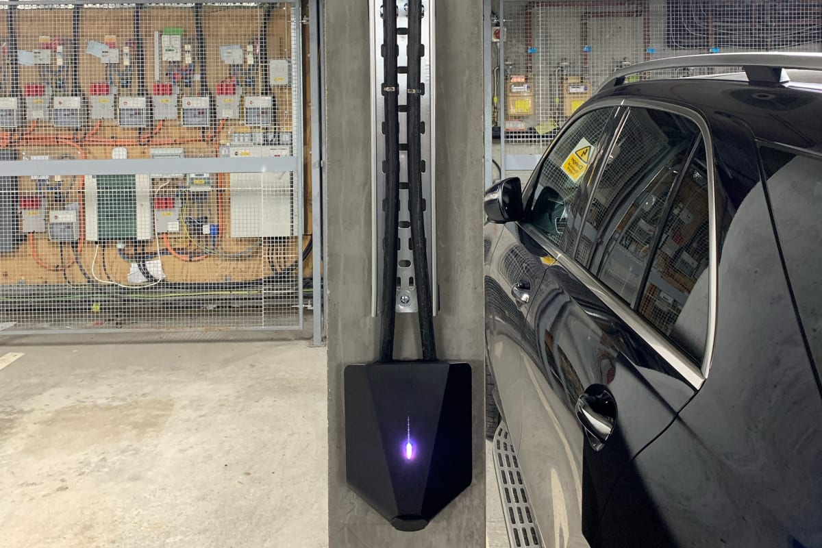 Compact Easee charger mounted flush to concrete pillar without obstructing the adjacent parking bay at Denver Court, Hendon