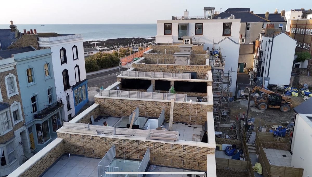 Aerial view of the Fort Mount new-build development under construction in Margate, Kent, showing the rooftop terraces and Kent coast in the background.