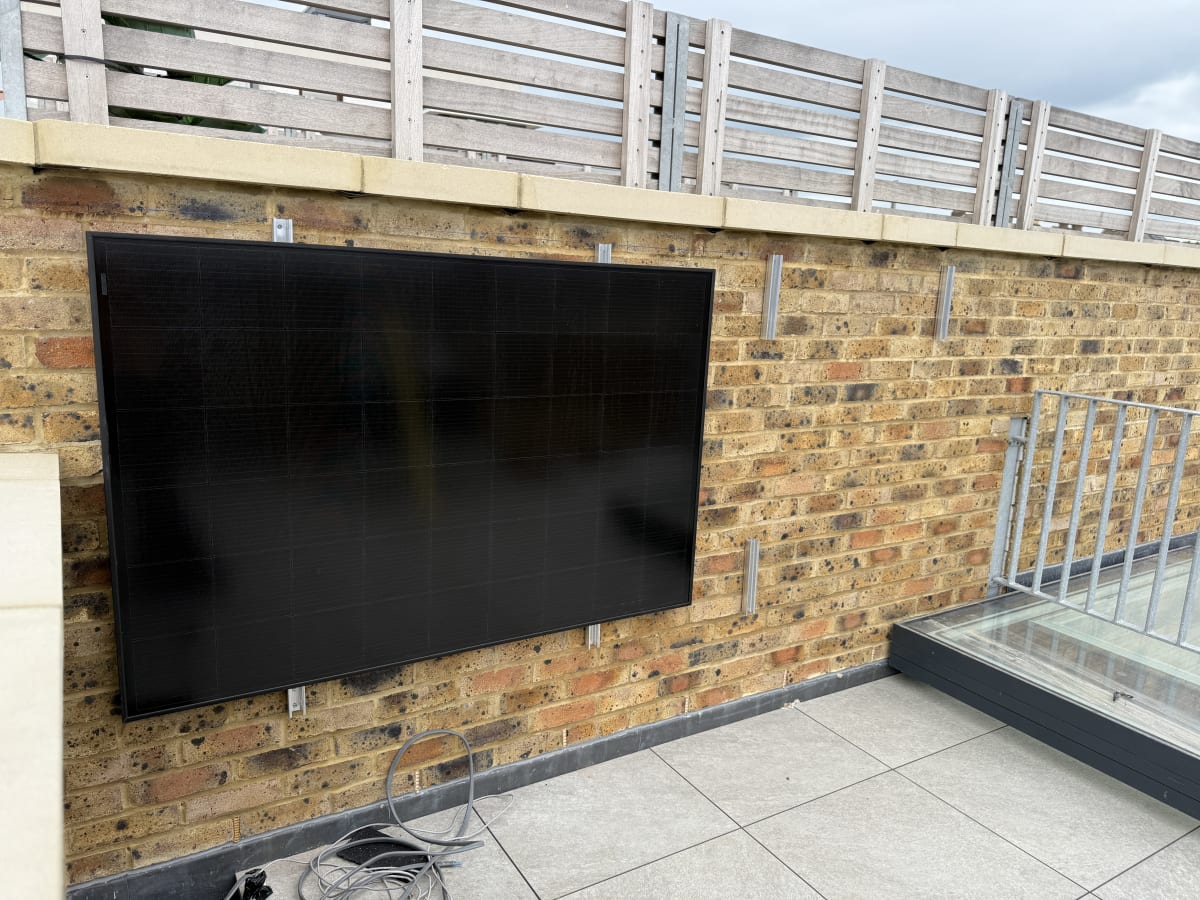Perlight all-black solar panel mounted flush to a brick terrace wall using the K2 WallPV MultiRail facade system at Fort Mount, Margate.