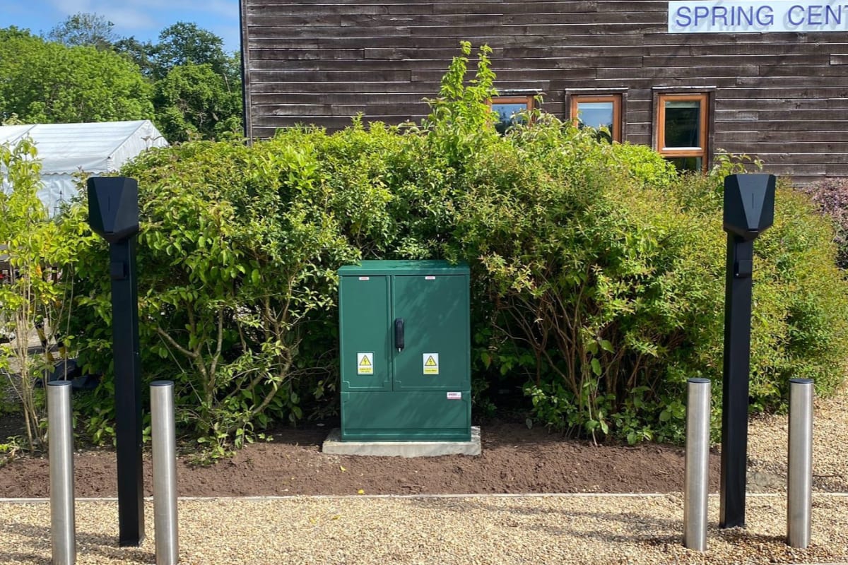 GRP electrical cabinet flanked by Easee charger pedestals at The Hospice of St Francis healthcare facility in Hertfordshire