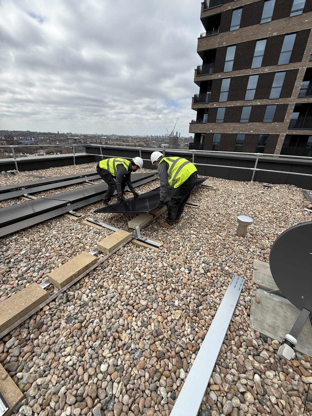 EV-ON engineer installing K2 S-Dome mounting on the Block A flat roof at Old Kent Road, Southwark, London.