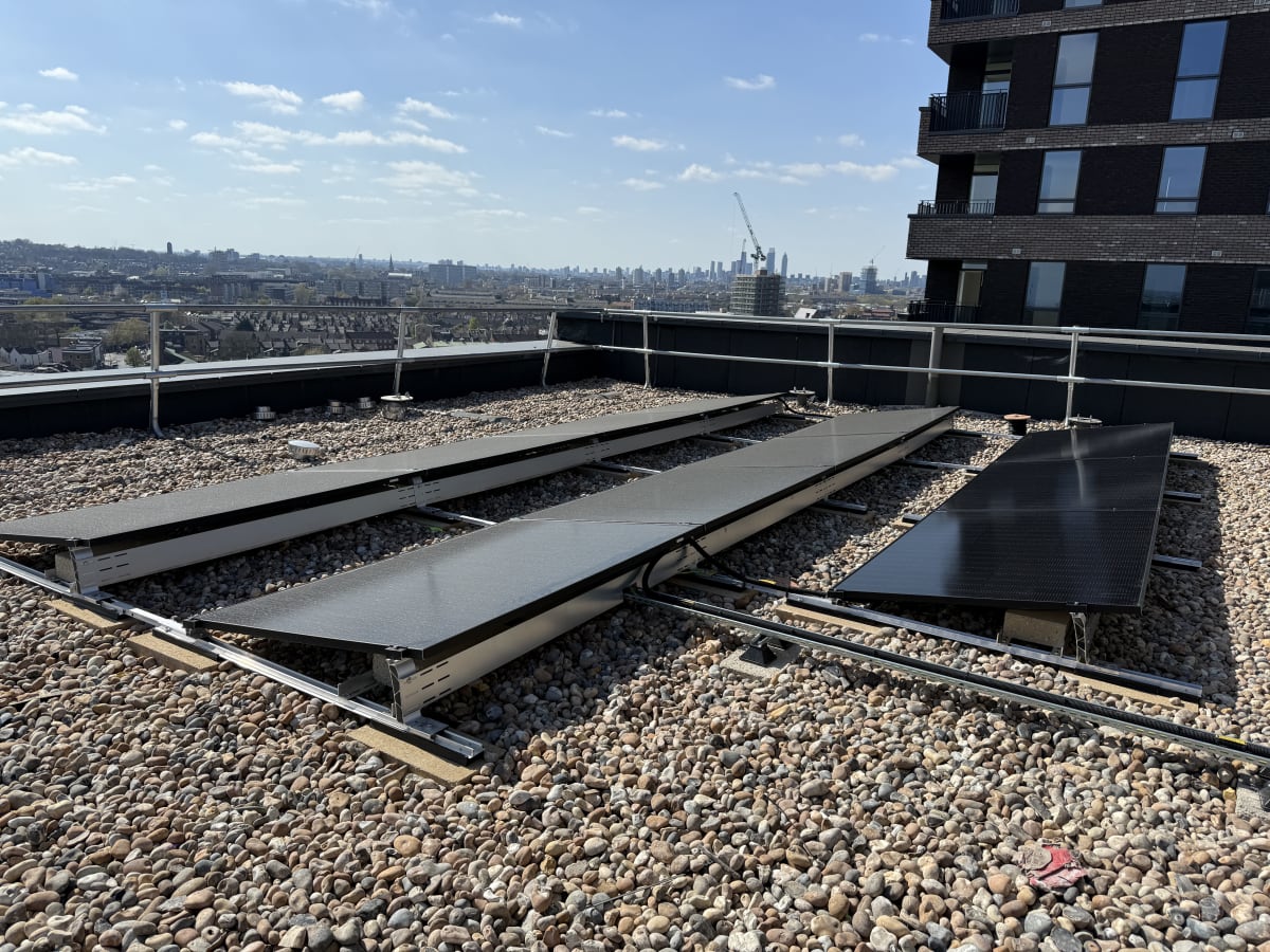 Top-down view of the completed south-facing solar PV array on the Block A upper roof at 840 Old Kent Road, Southwark.