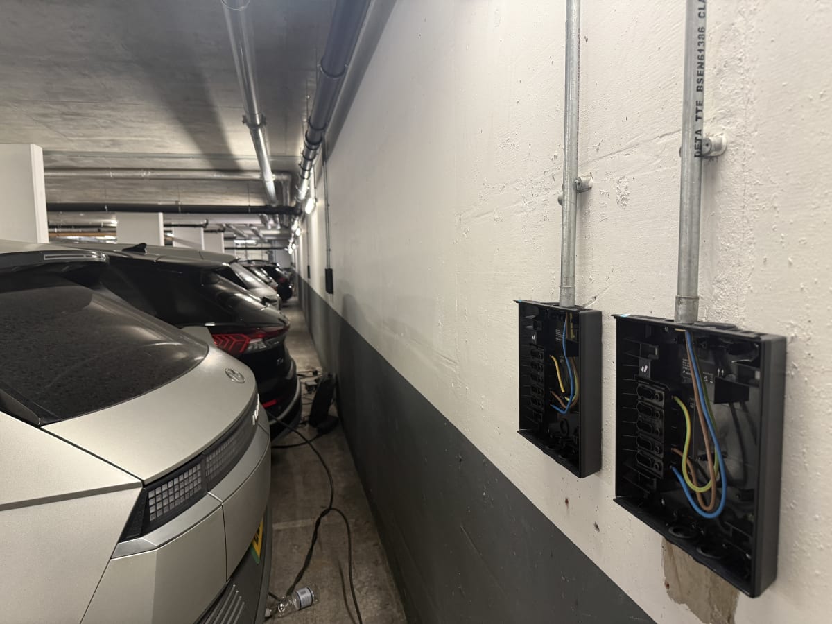 Existing communal electrical installation with exposed wiring in the underground car park at The Avenue, Kilburn.
