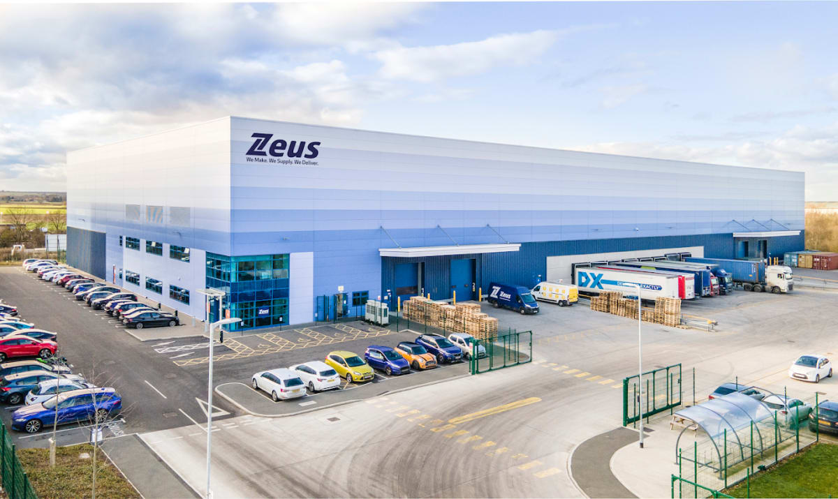 Aerial view of Zeus Packaging warehouse and staff car park at Stratton Business Park, Biggleswade