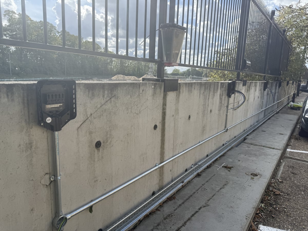 Easee charger backplates mounted on concrete perimeter wall with steel galvanised conduit at Touchlight, Hampton.