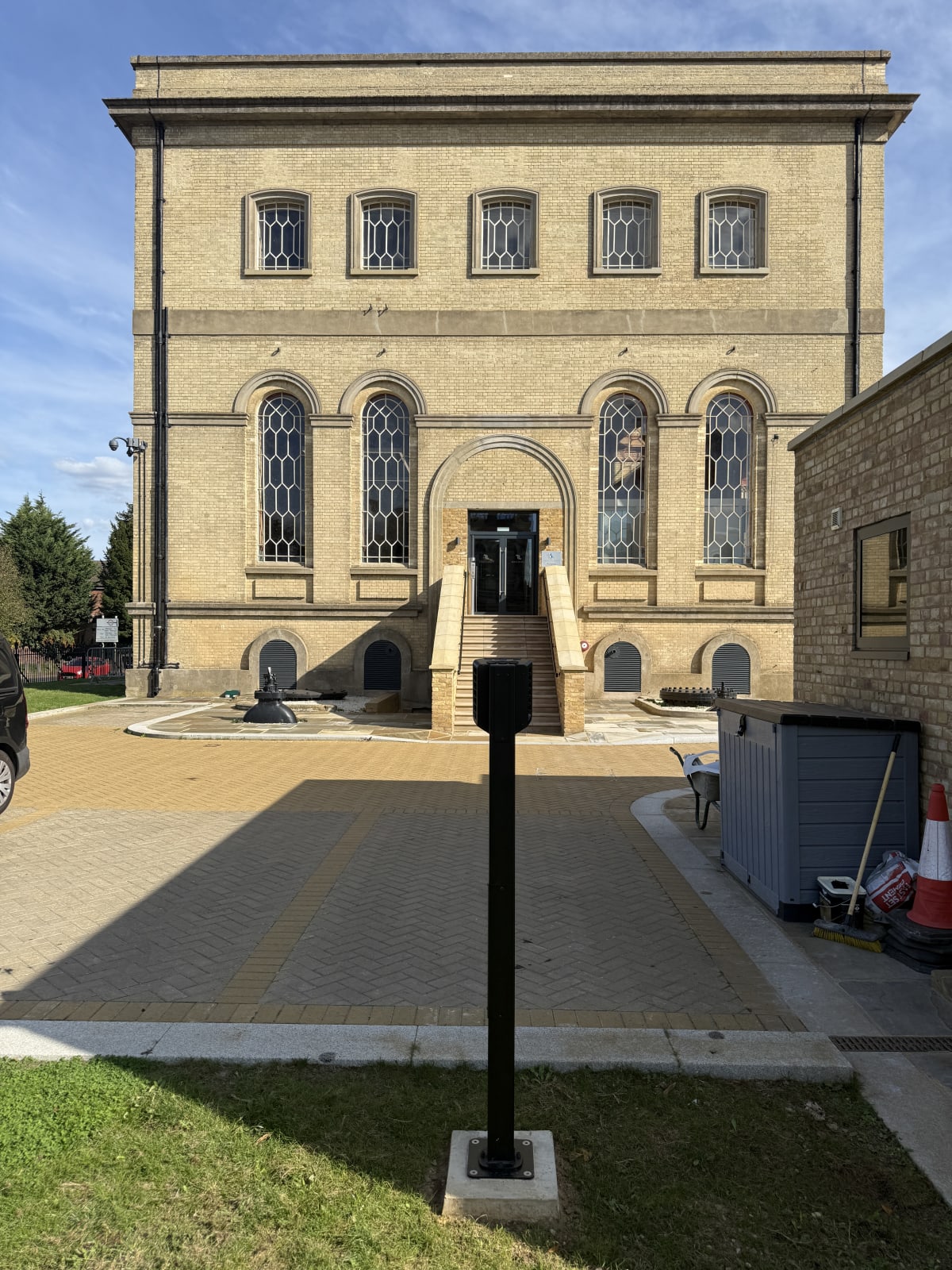 Pedestal charger at the security gatehouse with the full listed building facade visible at Touchlight, Hampton.
