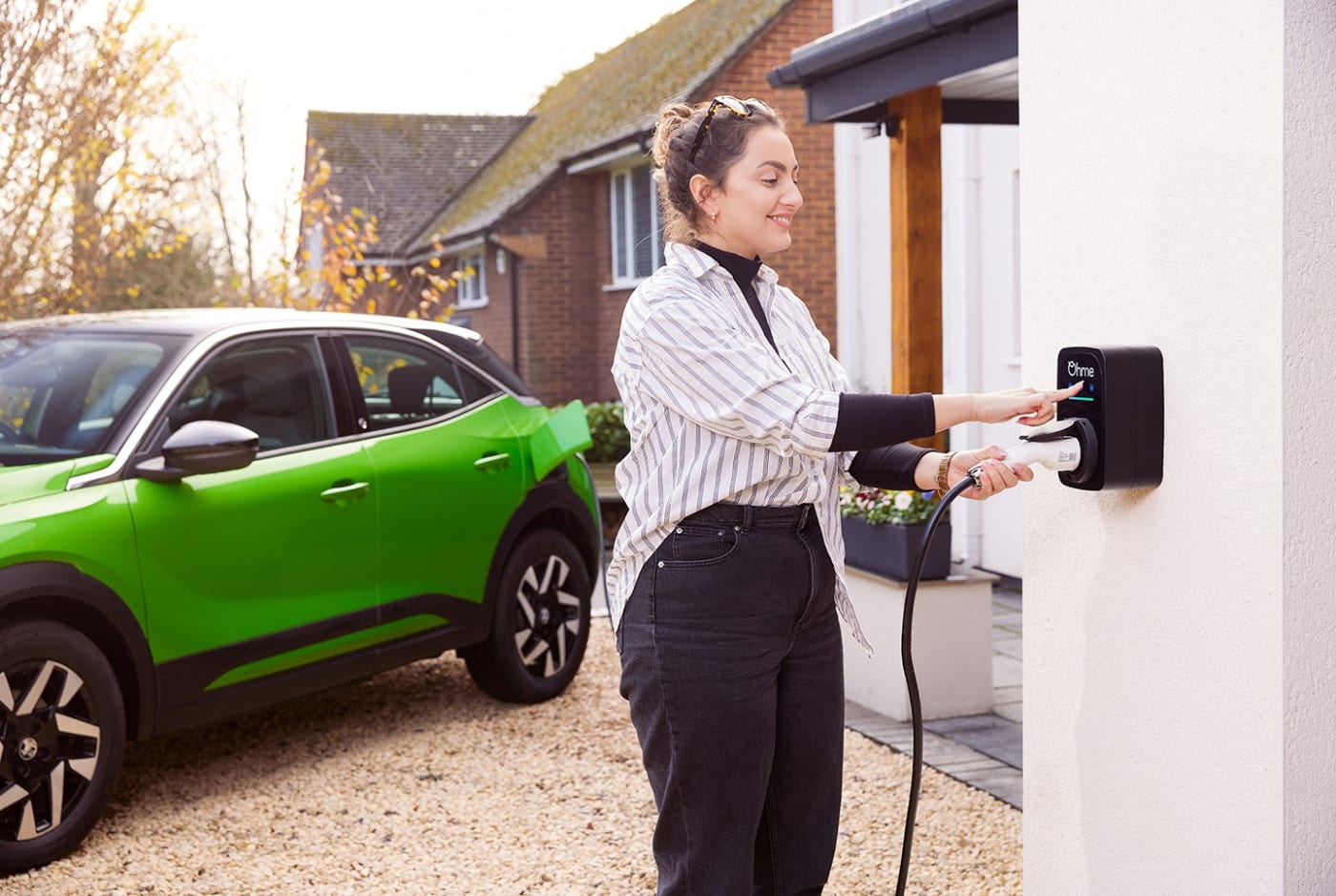 Ohme ePod home EV charger charging a car on a residential driveway