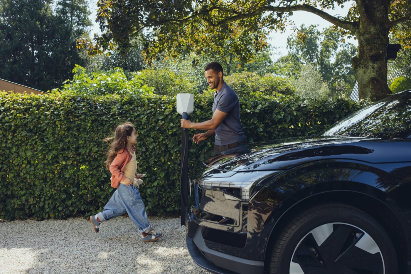A family charging their electric car at home with an Easee charger