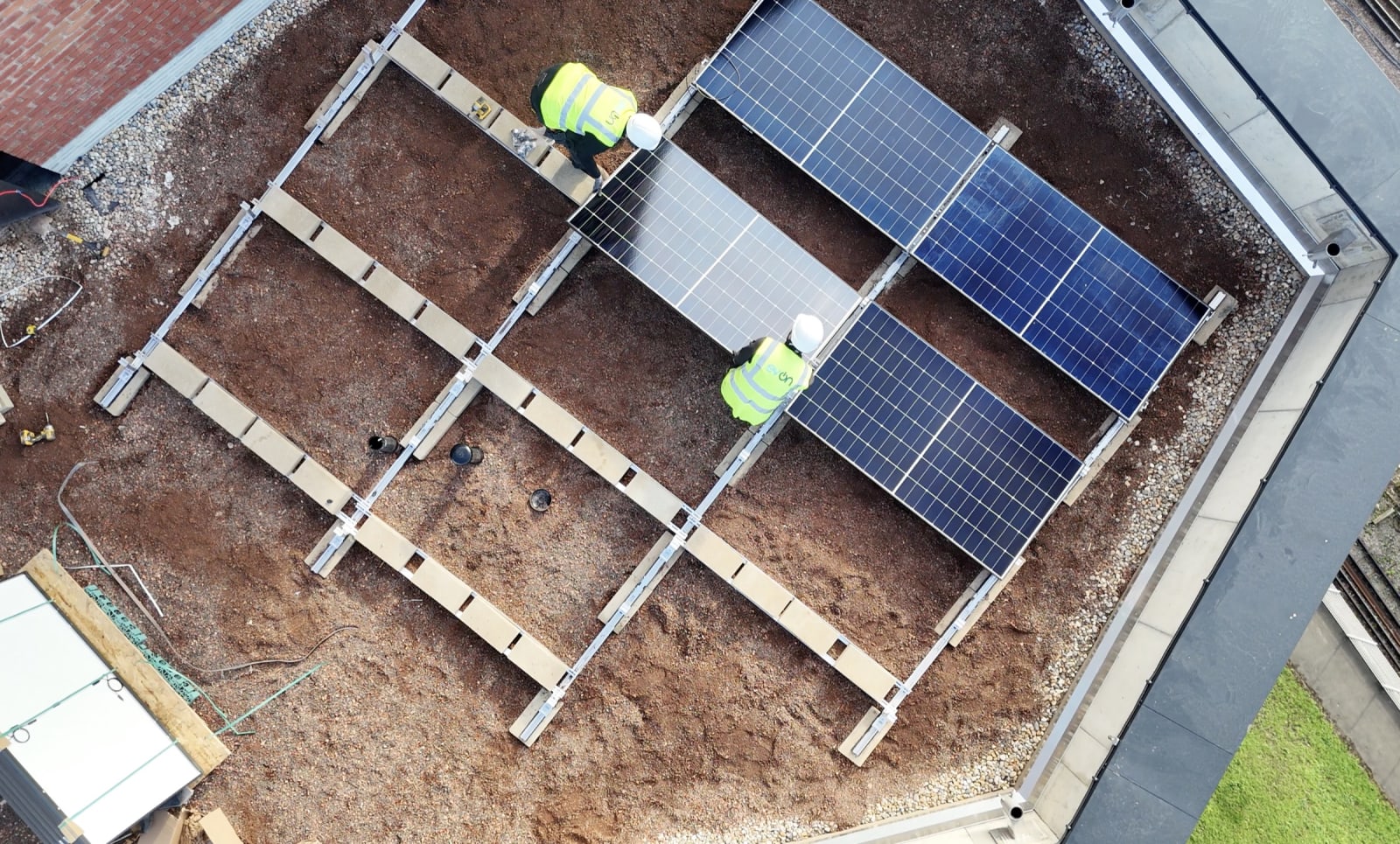 Drone view of an evon solar PV installation in progress on the Brooke House apartment tower roof, Gunnersbury Lane, Acton