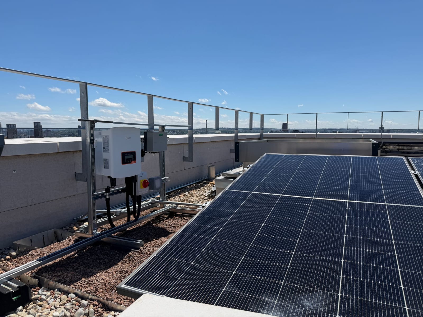 Framed solar PV array and Solis inverter on a co-living tower Zinco green roof in Canada Water, London.