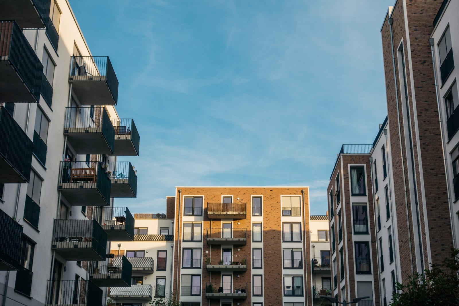 A modern apartment complex with EV charging in the car park