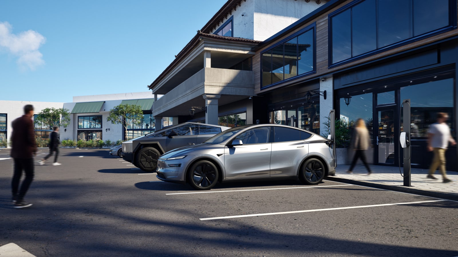 Tesla cars charging at Destination Charging points in a retail car park as pedestrians walk past.