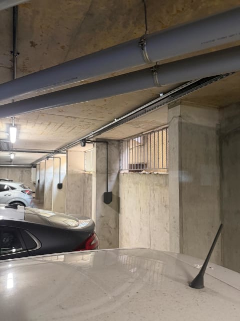 Easee EV chargers mounted on concrete pillars with overhead Wieland busbar at Portland Court underground car park in Hendon, London.