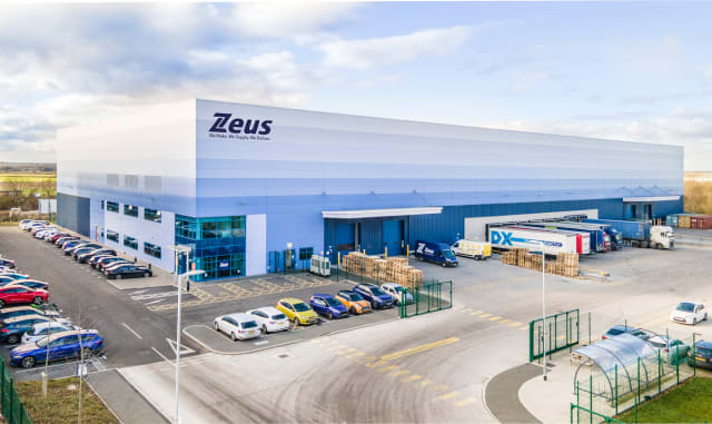 Aerial view of Zeus Packaging warehouse and staff car park at Stratton Business Park, Biggleswade