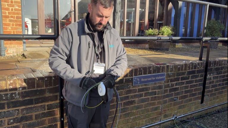 EV-ON engineer preparing cables during Easee charger installation at Purdicom workplace car park in Wantage.