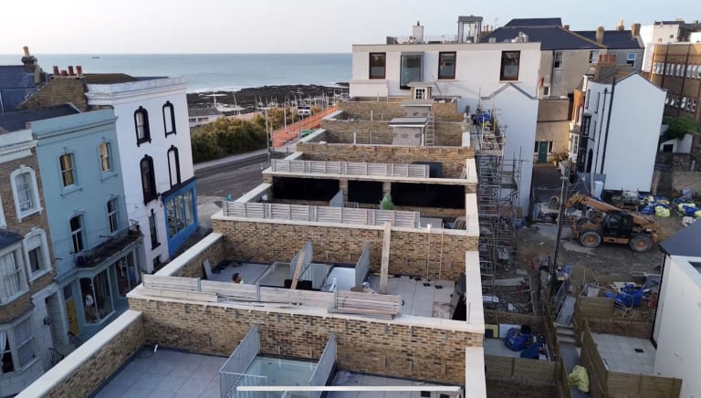 Aerial view of the Fort Mount new-build development under construction in Margate, Kent, showing the rooftop terraces and Kent coast in the background.