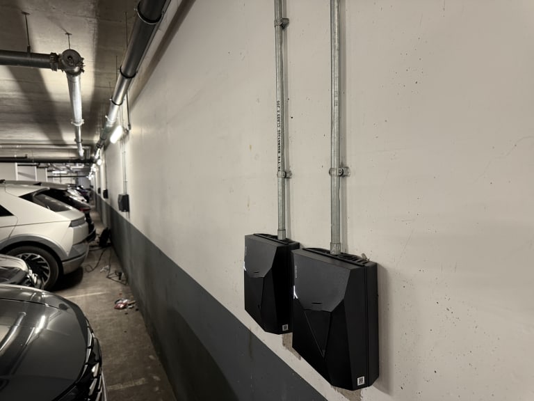 Two Nexblue Point 2 7kW chargers installed on the underground car park wall at The Avenue, Kilburn, London.