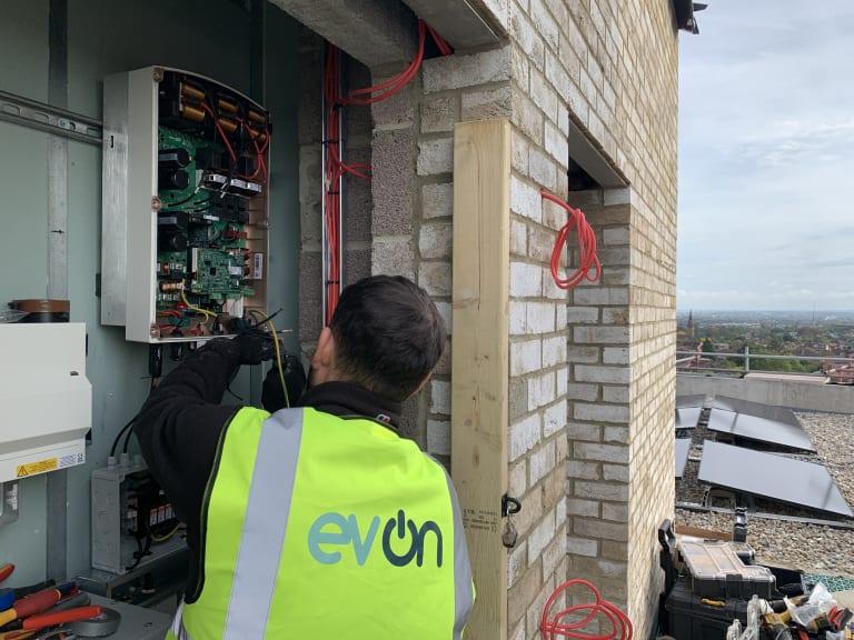 EV-ON engineer wiring the SolarEdge SE8K three phase inverter at The Mirador, Acton, London, during commissioning.