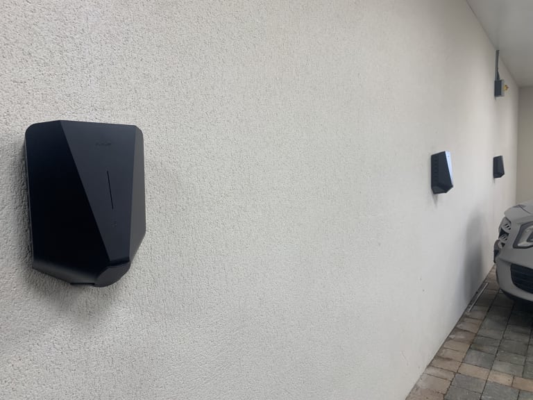 Two Easee One EV chargers installed on a wall in the car park at Wickliffe Court residential development, Hendon.