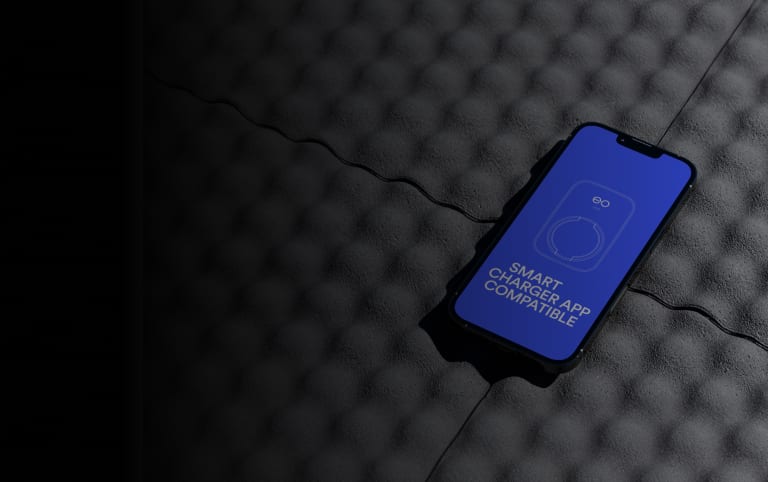 A smartphone showing EO smart charger app compatibility, used to control an EO Mini Pro 3 home charger.