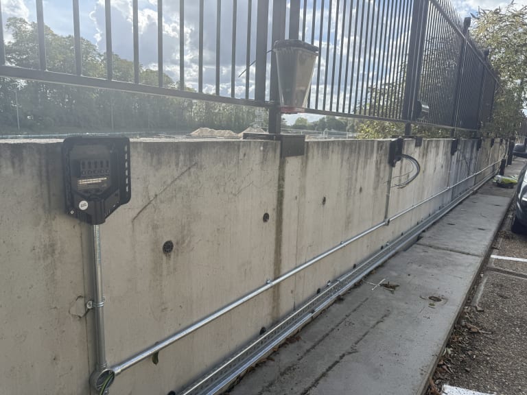 Easee charger backplates mounted on concrete perimeter wall with steel galvanised conduit at Touchlight, Hampton.