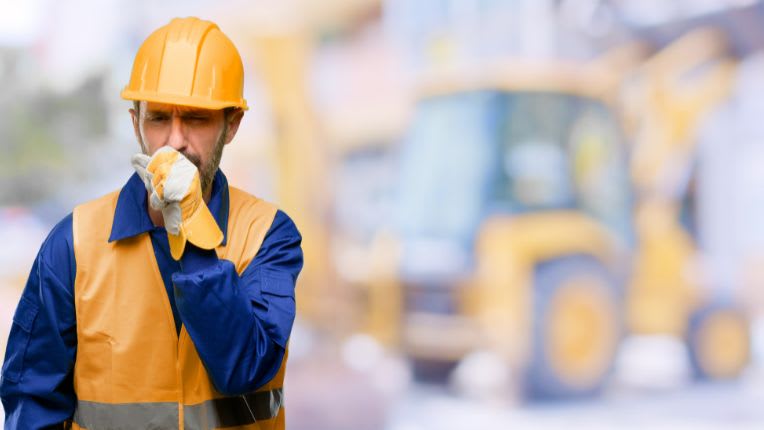 Cancer de la plèvre, mésothéliome : cancer généralement d'origine professionnelle (amiante). Image d'un ouvrier toussant sur un chantier.