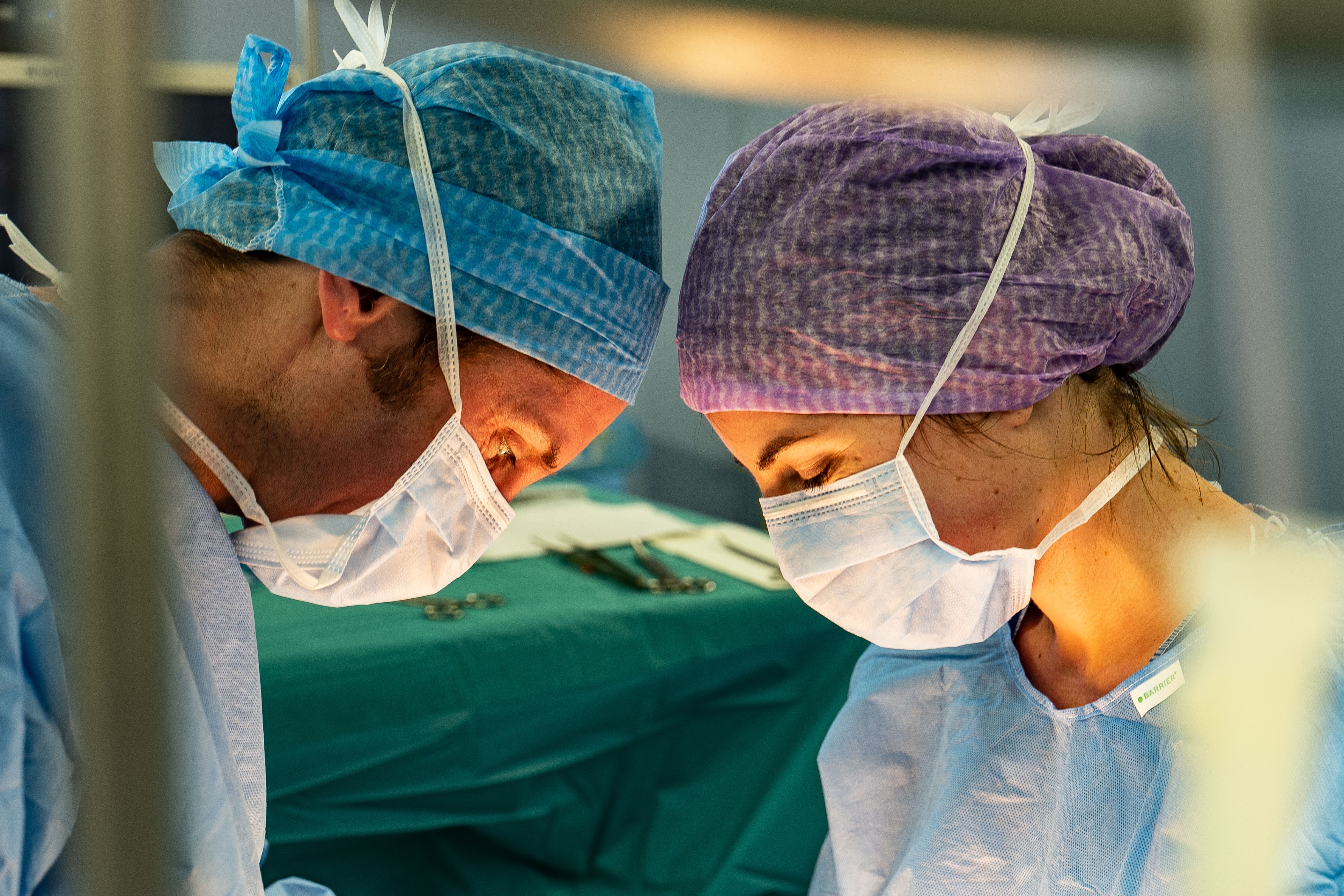Two surgeons operating with intense focus