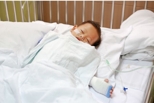 Enfant dans un lit d'hôpital. Le virus respiratoire syncytial (VRS) représente ainsi la cause la plus fréquente de bronchiolite chez le nourrisson.