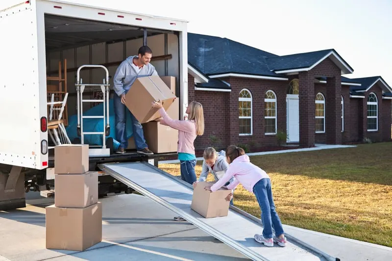 Professional movers packing and moving household items