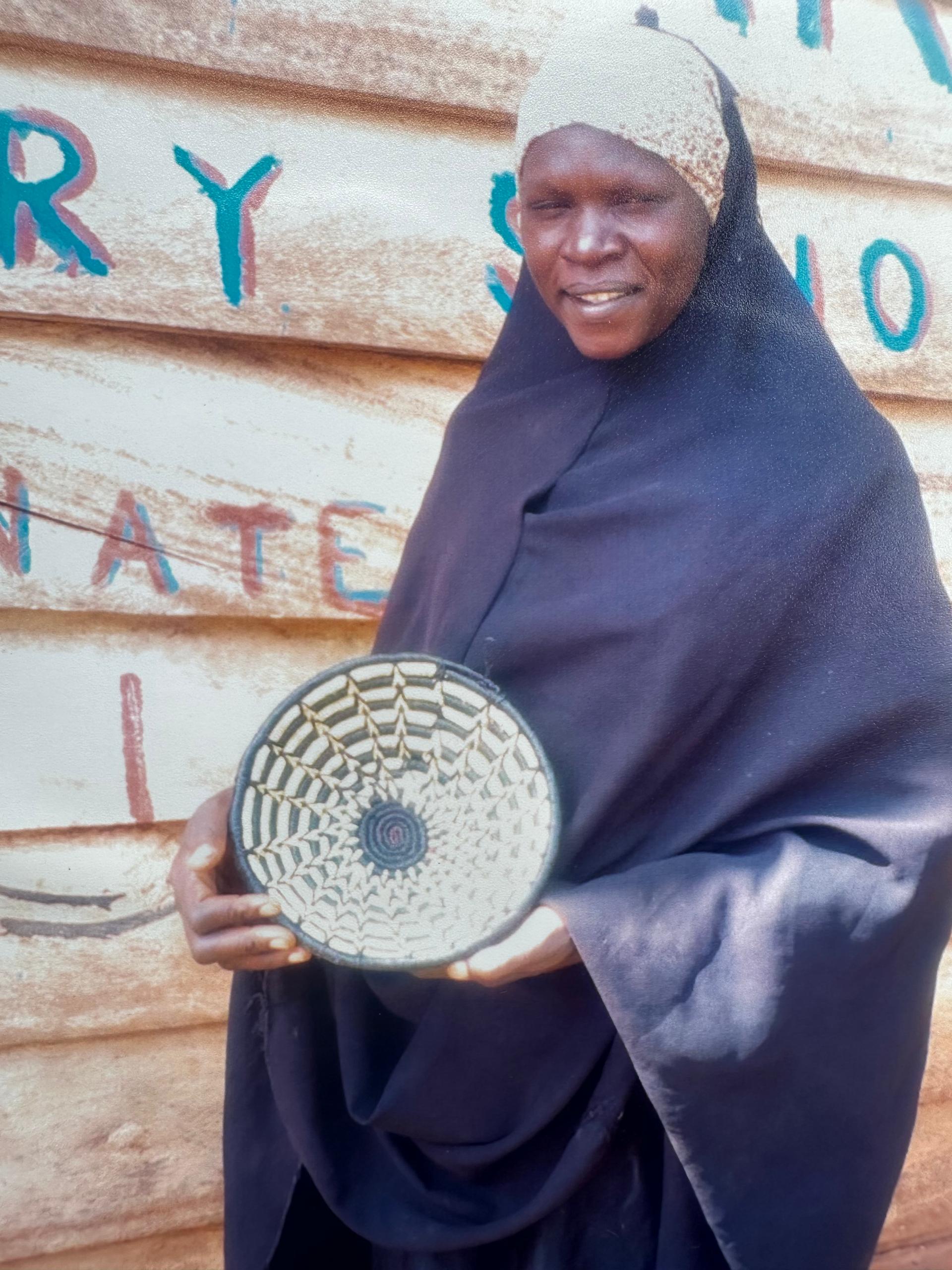 Woman weaving a basket in Uganda