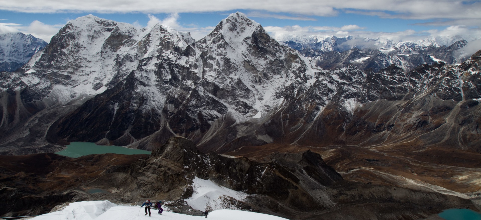 Panoramic summit view from Lobuche East Peak at 6,119m with Everest, Nuptse, and Lhotse visible on the horizon, Nepal
