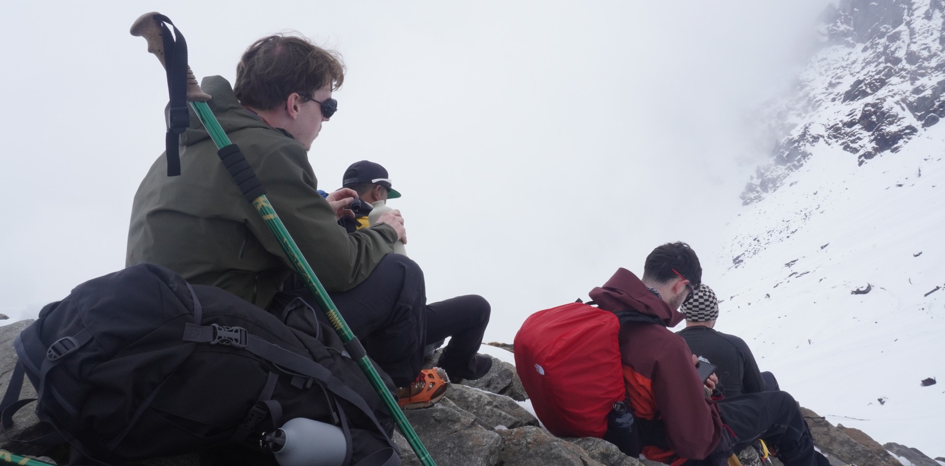 This image shows hikers taking a break during a high-altitude trek during mera peak climbing.