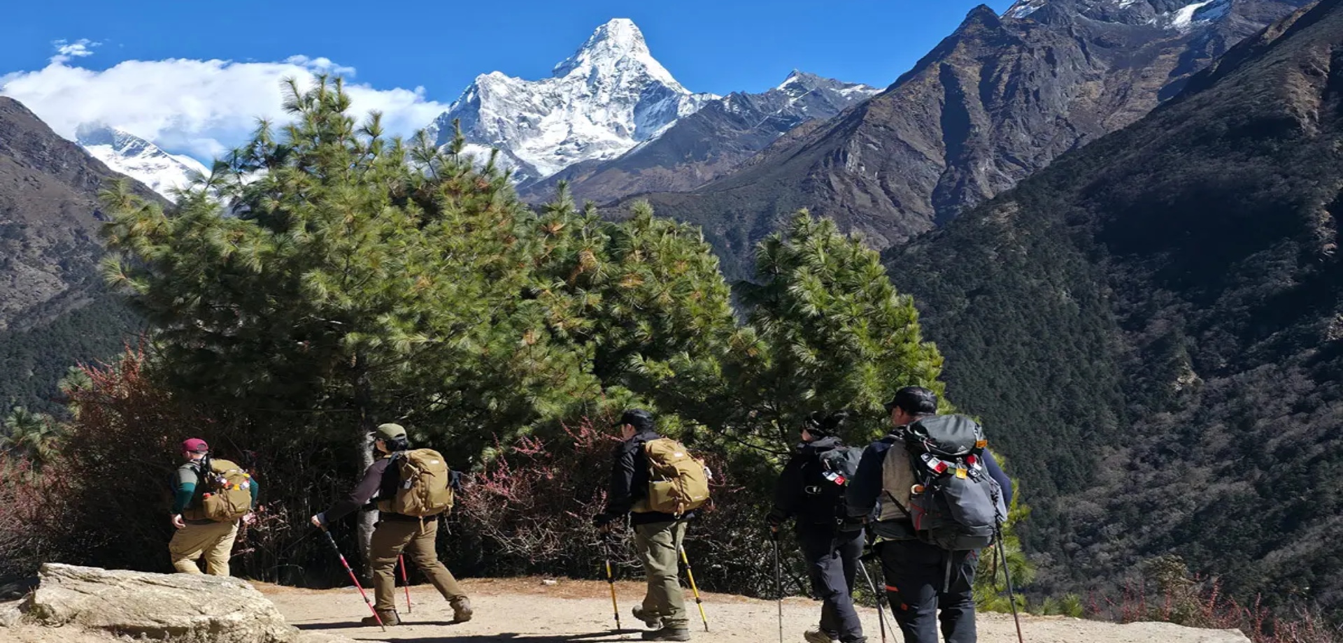Trekkers walking through Namche Bazaar on the approach trek to Island Peak base camp