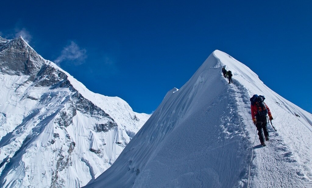 Hiker descending a steep mountain trail during training