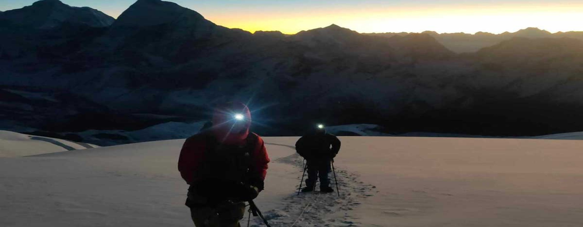 mera-peak-summit-night-headlamps Headlamp-lit line of climbers on Mera Peak summit night