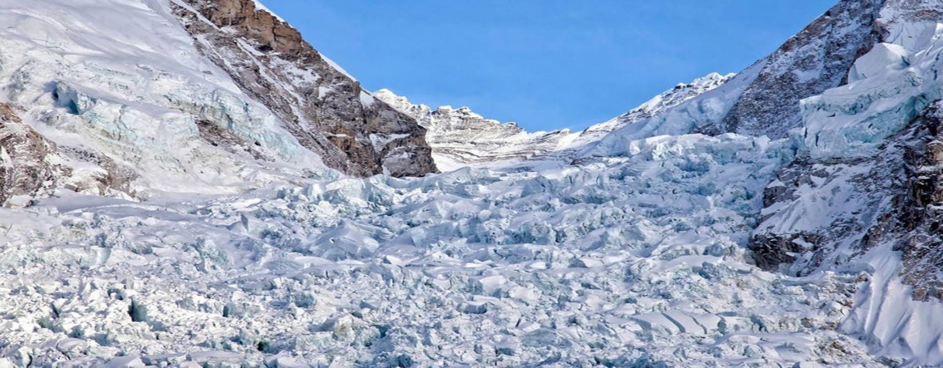 Trekkers crossing the rocky moraine of the Khumbu Glacier on the way to Everest Base Camp