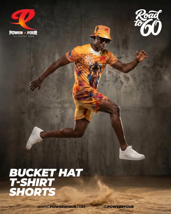 Male model in orange tie-dye bucket hat, t-shirt and shorts jumping in Power X Four 246 Massive Crop Over 2026 costume