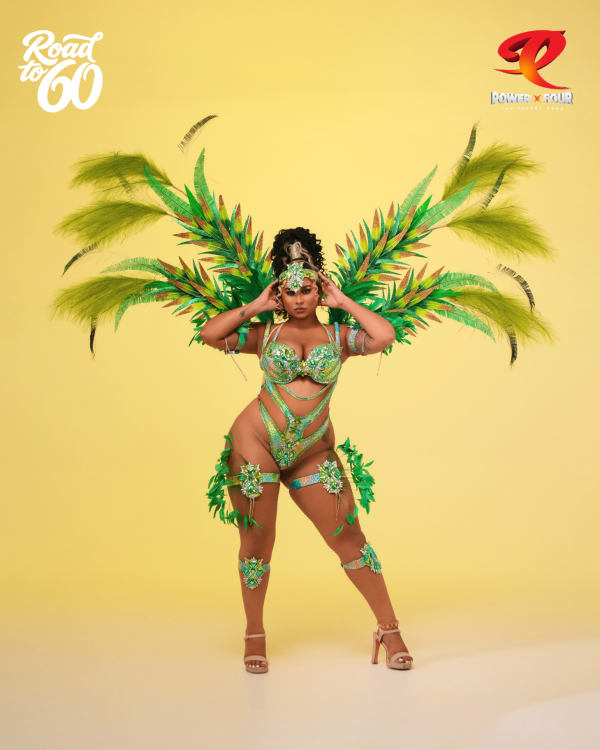 Woman in green and gold Mystical Palms feathered carnival costume by Power X Four for Crop Over 2026