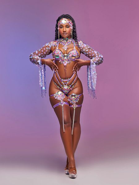 Female model in purple, pink and silver beaded bikini carnival costume with headpiece for Vivid Lux Carnival Solace section at Miami Carnival 2026