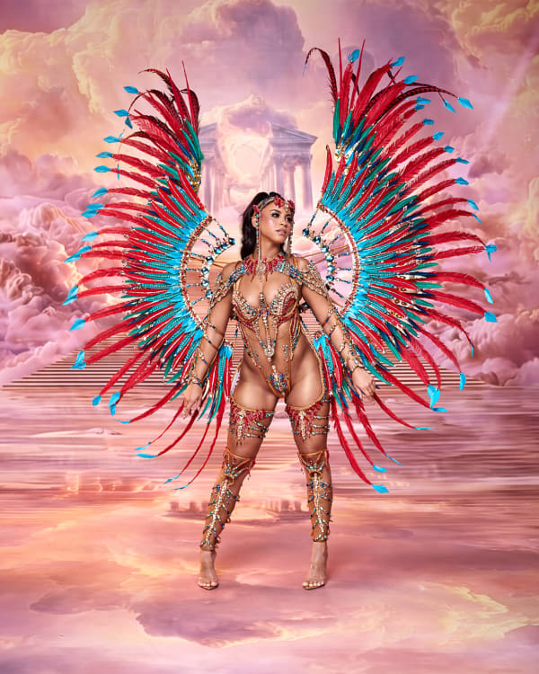 Female carnival dancer in Charis section by Natasha Marshall wearing red and teal feathered wings with beaded bikini costume for Trinidad Carnival 2027