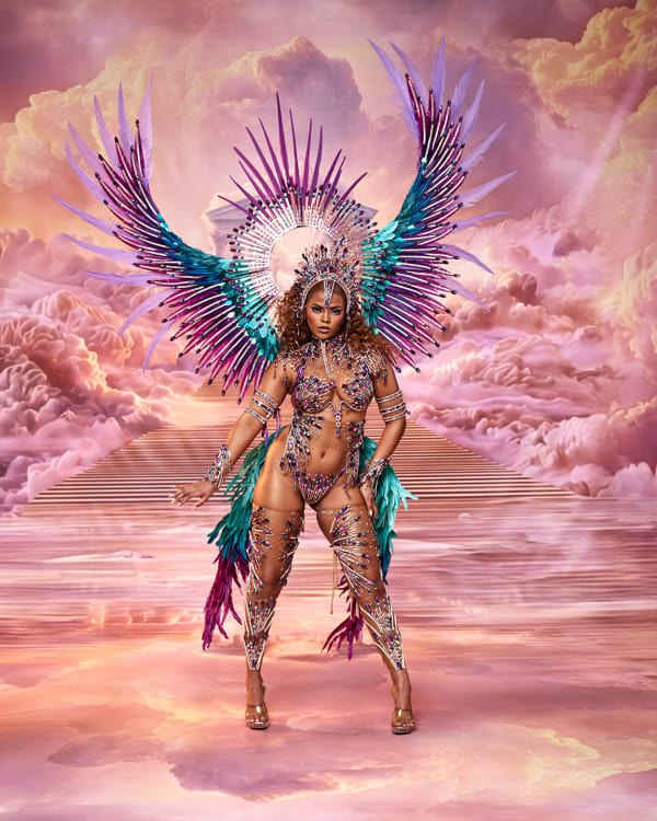 Female carnival performer in Eris section by Richard Dookhdeen for Tribe at Trinidad Carnival 2027 wearing purple teal feathered wings and beaded bikini costume